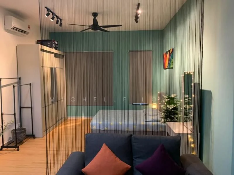Room features: green painted walls, wooden flooring, 1 wall-mounted split AC, 5-blade ceiling fan, bed with mattress, decorative painting on wall, window with roller blinds, sofa with cushions, decorative plants, shelf unit, ambient lighting; style: modern.