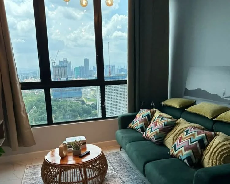 Living features: green fabric sofa, decorative cushions with geometric patterns, round wooden coffee table, area rug, floor-to-ceiling windows, curtains, city skyline view, wall-mounted artwork; style: modern; view: city.