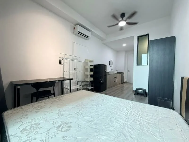 Bedroom features: queen-size bed with floral-patterned bedding, 5-blade ceiling fan with light, wall-mounted air conditioning unit, wooden flooring, desk with chair, black refrigerator, kitchenette with cabinets, countertop with sink, door leading to bathroom, built-in wardrobe; style: modern.
