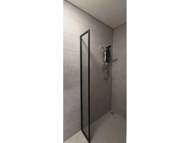 Bathroom features: walk-in shower with glass panel, grey tile cladding on walls, grey tile flooring, shower head, wall-mounted shower controls, drain in floor; style: modern.