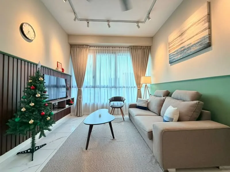 Living features: 3-seater fabric sofa in beige, wooden coffee table, TV console with wall-mounted TV, floor-to-ceiling windows, sheer curtains, decorative wall clock, area rug with neutral color, wall-mounted light fixtures, green accent wall, wood paneling, decorative painting, Christmas tree with ornaments; style: modern; view: city.