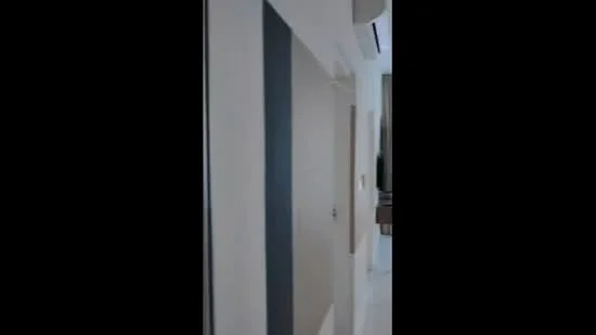 Room features: white painted walls, grey accent wall, marble tile flooring, recessed downlights, air conditioning unit, door, wall-mounted switch; style: modern.