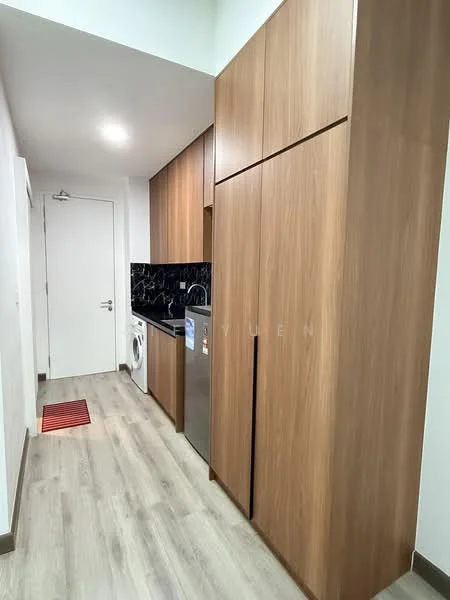 Kitchen features: wood cabinetry, black countertop, stainless-steel refrigerator, built-in oven, washing machine, grey vinyl plank flooring, white walls, door to hallway, red accent rug; style: modern.
