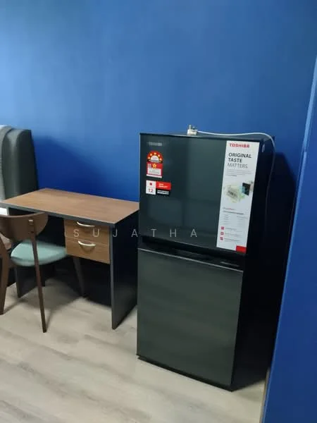 Room features: dark green fridge, wooden dining table, three wooden dining chairs, blue painted walls, laminate flooring.