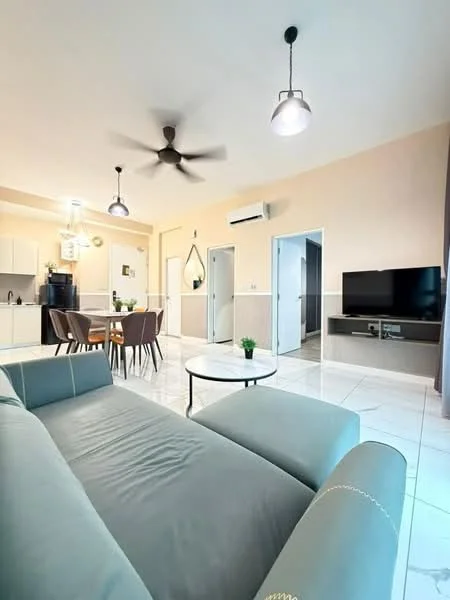 Living features: 3-seater fabric sofa in light blue, round coffee table with black metal legs, ceiling fan with light, wall-mounted TV, TV console, dining table with four chairs, white tiled flooring, neutral painted walls, recessed lighting, decorative mirror, plant in ceramic pot; style: modern. Kitchen features: kitchen island, stainless-steel sink, built-in cabinets, white cabinetry, black countertop, refrigerator, oven, microwave; style: modern. Room features: doorway leading to bathroom, doorway leading to hallway.