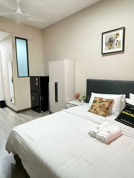 Bedroom features: queen-size bed with white bedding, upholstered headboard in grey, 2 white towels on bed, decorative pillow with print, nightstand with lamp, framed artwork on wall, built-in wardrobe with white doors, black mini fridge, wooden flooring, ceiling fan, mirror on wall, window with glass panel, light beige painted walls; style: modern.