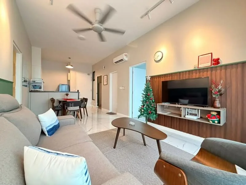 Living features: 3-seater fabric sofa in grey, decorative cushions in blue and white, wooden coffee table, area rug in neutral color, wall-mounted TV, TV console with wooden finish, decorative wall clock, Christmas tree, recessed downlights, 5-blade ceiling fan, white tiled flooring, green accent wall, dining table for two in background; style: modern.