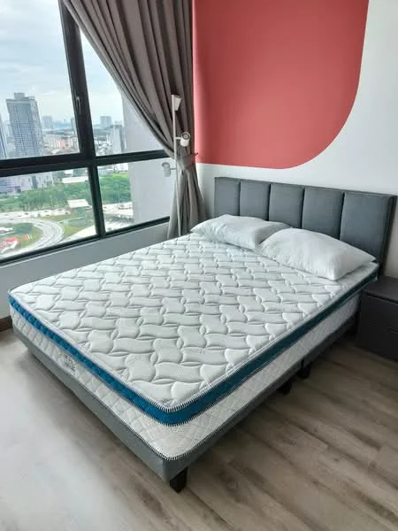 Bedroom features: queen-size bed with grey upholstered headboard, white bedding with two pillows, light wood flooring, red accent wall, floor-to-ceiling windows, curtains in grey fabric, nightstand with drawer, city view from window; style: modern; view: city.