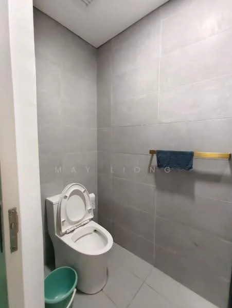 Bathroom features: white toilet, grey tiled walls, grey tiled flooring, gold towel rack, blue towel, green waste bin, recessed lighting; style: modern.