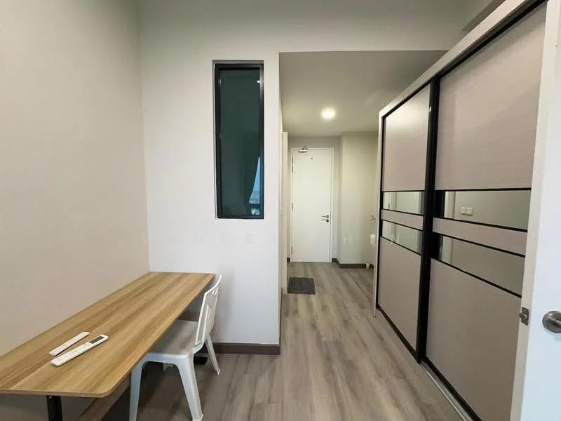 Room features: wooden flooring, light grey painted walls, small window with green view, white table, white chair, sliding door with frosted glass panels, door leading to hallway, ceiling light fixture; style: modern.