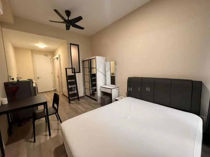 Bedroom features: queen-size bed with upholstered headboard, wooden flooring, 5-blade ceiling fan, study desk, black dining table, white wardrobe, kitchenette with sink, refrigerator, wall-mounted mirror, neutral painted walls, window with natural light; style: modern.