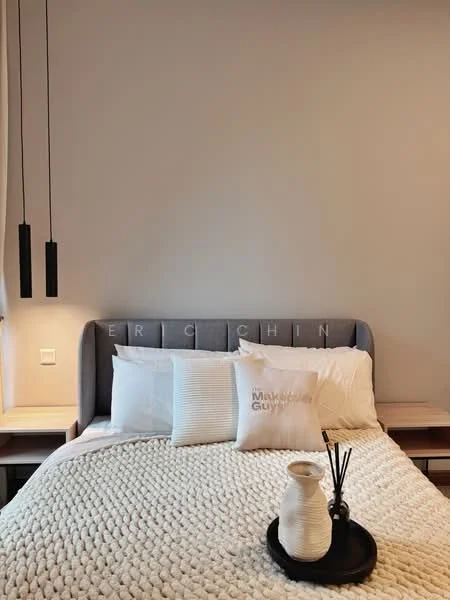 Bedroom features: king-size bed, upholstered headboard in grey, white bedding with textured throw, two bedside tables, table lamps on each side, decorative vase, reed diffuser, neutral wall colour, floor-to-ceiling windows, sheer curtains; style: modern.