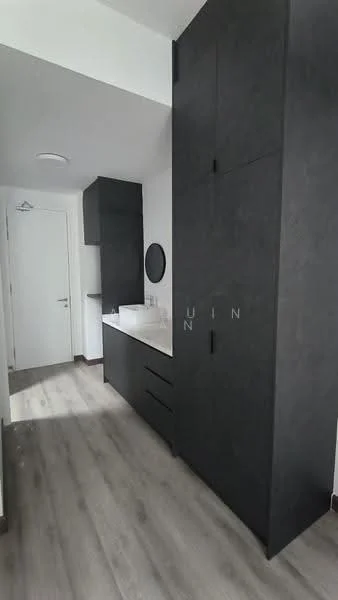 Room features: dark cabinetry, white countertop, round mirror, single-basin sink, drawer storage, wall-mounted cabinet, light wood flooring, white painted walls; style: modern.