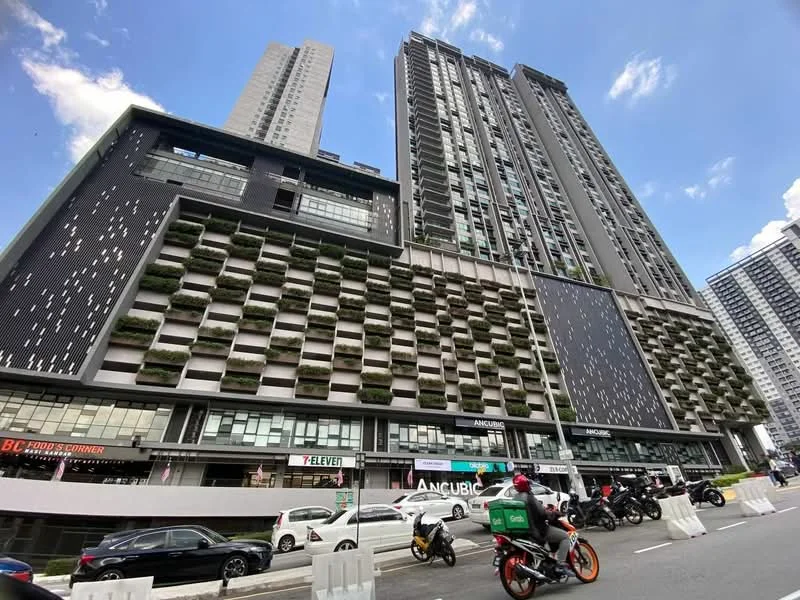 Exterior type: high-rise condominium; features: glass curtain wall, exposed concrete facade, recessed balconies, vertical fins, feature lighting at night, manicured landscaping at base, multiple storeys, commercial space at ground level, surrounded by urban context; style: modern.