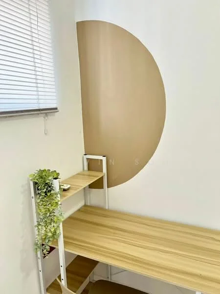 Room features: wooden desk, white walls, decorative wall with circular design, window with blinds, shelf unit, greenery decoration; style: modern.