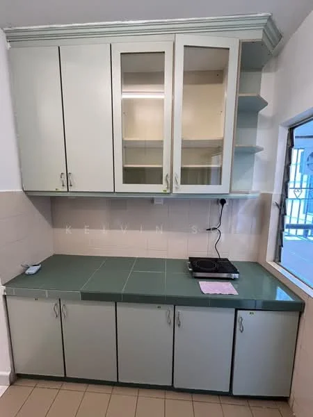 Kitchen features: green countertop, light green cabinetry, upper cabinets with glass fronts, lower cabinets, built-in stove, tile backsplash, wall-mounted electrical outlet, window with view to outside, neutral tile flooring; style: modern.