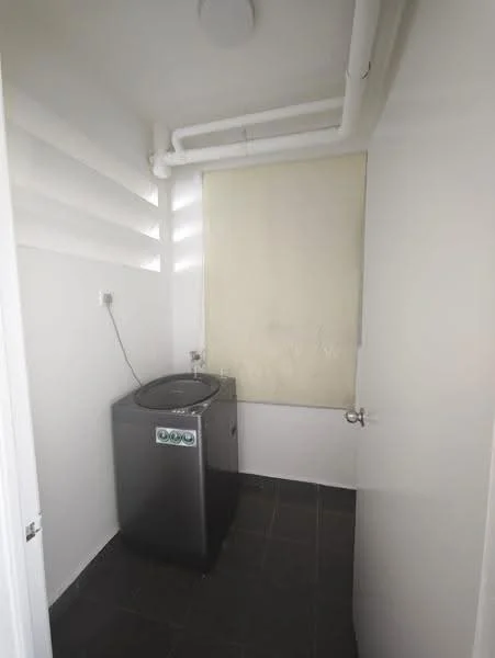 Laundry features: top-load washing machine in grey, black tiled flooring, white painted walls, window with roller blind, exposed plumbing pipes.
