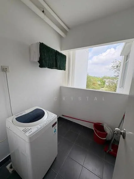 Laundry features: top-load washing machine, white walls, black tile flooring, window with view, green towel hanging, bucket, plumbing visible; view: garden.