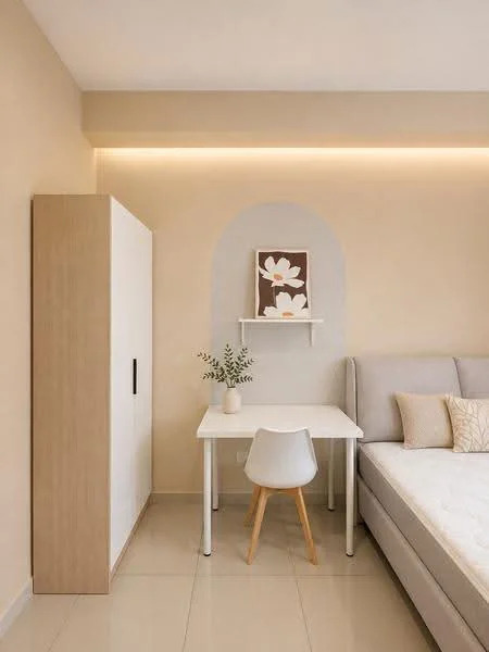 Bedroom features: light beige painted walls, white ceiling, tile flooring, queen-size bed with light grey upholstered headboard, white bedside table, small white desk with wooden legs, white chair with wooden legs, decorative wall art with floral design, shelf mounted on wall, greenery in vase, soft lighting strip above the bed, built-in wardrobe with wooden finish; style: modern.
