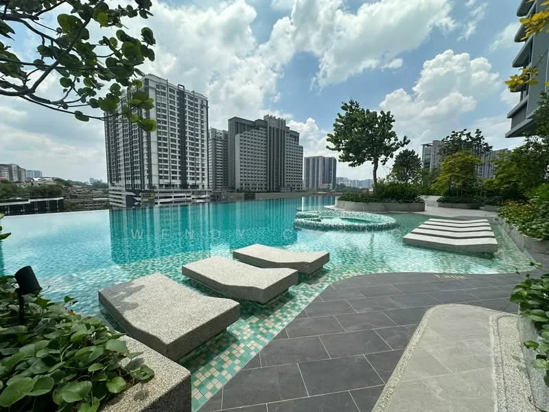 Exterior type: high-rise condominium; features: infinity pool, pool deck with loungers, landscaped garden, tropical landscaping, stone-paved walkway, surrounded by high-rise buildings, clear blue sky, water feature with spa, mature trees; style: modern.