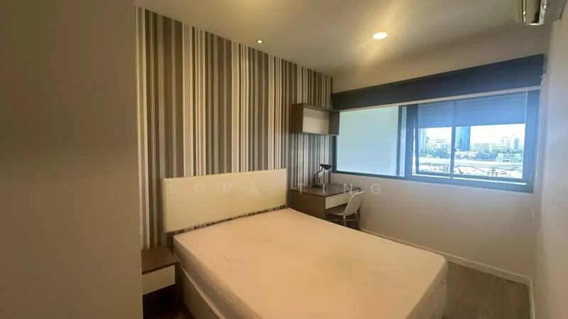 Bedroom features: queen-size bed, striped wallpaper in grey and white, wooden bedside table, desk with chair, floor-to-ceiling window, roller blinds, air conditioning unit, carpet flooring; style: modern; view: city.