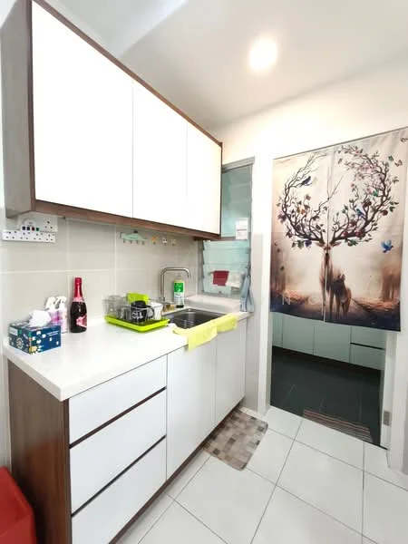 Kitchen features: white cabinetry with flat-panel doors, stainless-steel sink, chrome pull-down faucet, white quartz countertop, tile backsplash, built-in oven, microwave, refrigerator, kitchen towel, green dish rack, floor tiles in white, wall-mounted storage, decorative wall art with tree design; style: modern.