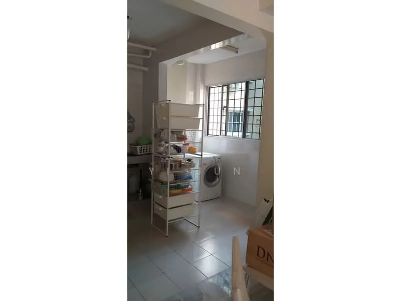 Laundry features: white shelving unit, washing machine, grey tiled flooring, white walls, window with grid pattern, storage boxes, light fixture on ceiling.