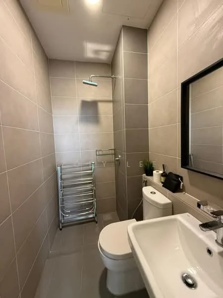 Bathroom features: grey tiled walls, light grey tiled flooring, walk-in shower with glass enclosure, rain shower head, chrome wall-mounted faucet, white sink, one-piece toilet, heated towel rail, framed mirror, wall-mounted shelf, decorative plant; style: modern.