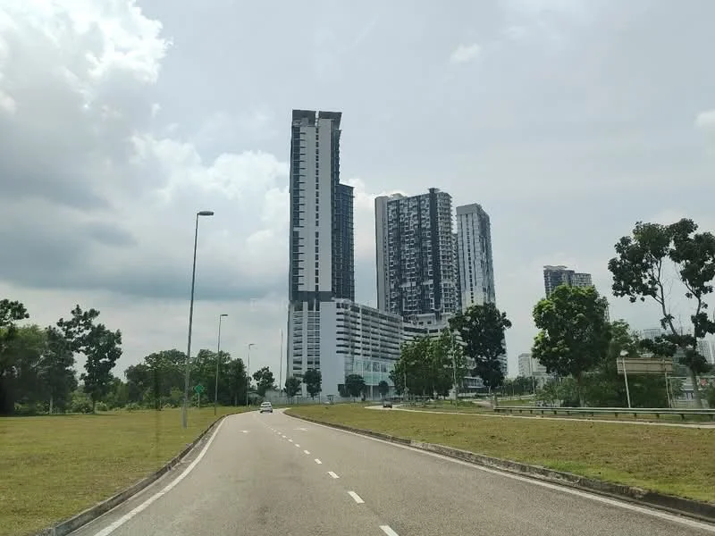 Exterior type: high-rise condominium; features: glass curtain wall, white painted facade, multiple balconies, surrounded by greenery, urban context, manicured lawn, paved road, adjacent to highway; style: modern.