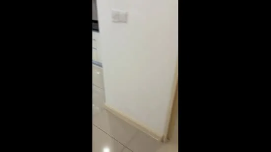 Room features: white painted walls, glossy tile flooring, light switch, baseboard trim.