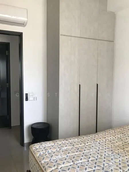 Bedroom features: queen-size bed, built-in wardrobe with grey finish, black bedside table, wall-mounted air conditioning unit, neutral wall colour, tile flooring, window with natural light, decorative bedspread with pattern; style: modern.