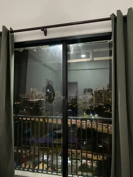 Room features: floor-to-ceiling windows, black sliding glass door, grey curtains, balcony view, city skyline view, wooden railing, indoor plants visible, decorative items on balcony; style: modern; view: city.