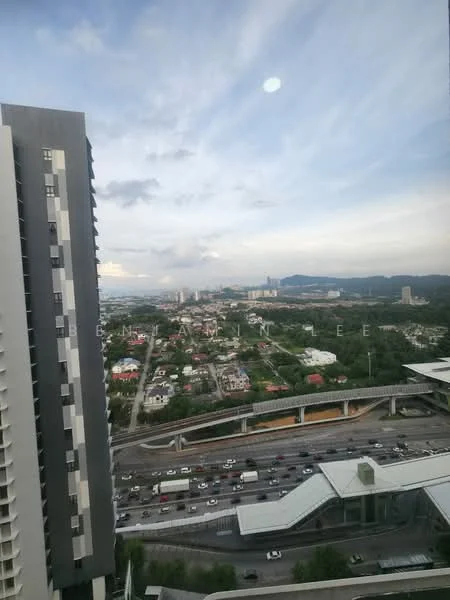 Exterior type: high-rise condominium; features: city skyline view, surrounded by greenery, highway visible, multi-storey building, modern facade, balconies on upper floors; style: modern.