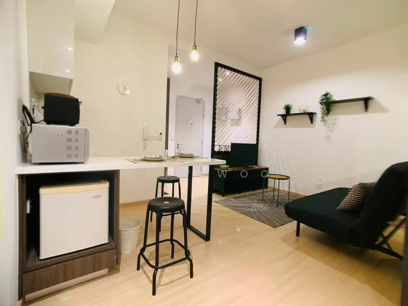 Living features: black fabric sofa bed, white wall, light wood flooring, black metal bar stools, white countertop, microwave, mini fridge, pendant lighting, decorative wall shelves, greenery decor, area rug with geometric pattern, open layout, wall-mounted artwork; style: modern.