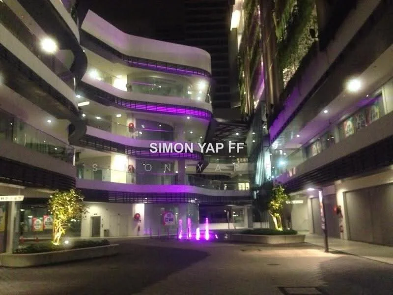 Exterior type: mixed-use development; features: curved architectural design, multi-level structure, outdoor water feature with lighting, landscaped areas with trees, glass facade, illuminated pathways, balconies with planters, night lighting, open-air courtyard, modern aesthetic; style: contemporary.