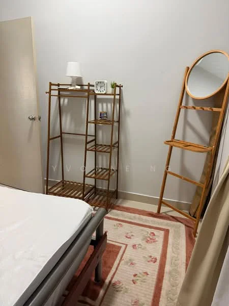 Room features: light grey painted walls, white ceiling, wooden shelving unit, round mirror on wooden stand, table lamp on shelf, decorative plant on shelf, area rug with floral pattern, bed frame without mattress; style: minimalist.