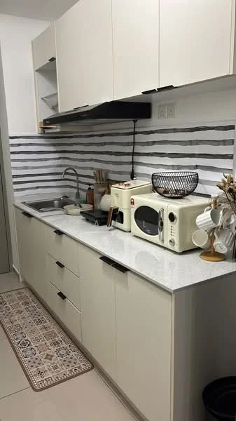 Kitchen features: white cabinetry with flat-panel doors, grey and white striped backsplash, marble countertop, single-bowl stainless-steel sink, chrome pull-down faucet, built-in microwave in cream color, toaster in cream color, decorative bowl on countertop, kitchen rug with patterned design, open shelving above countertop; style: modern.