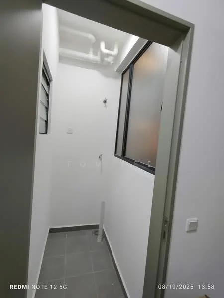 Laundry features: white painted walls, grey tile flooring, window with metal frame, plumbing fixtures visible, ceiling with exposed pipes, light fixture on ceiling, corner space for appliances, door frame with handle.