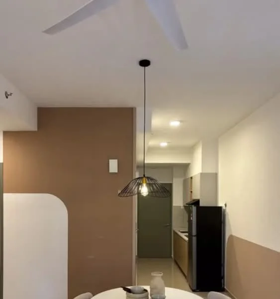 Dining features: round dining table, 4 dining chairs, pendant lamp with wire shade, 5-blade ceiling fan, cream painted walls, brown accent wall, recessed downlights, kitchen area visible in background, black refrigerator; style: modern.