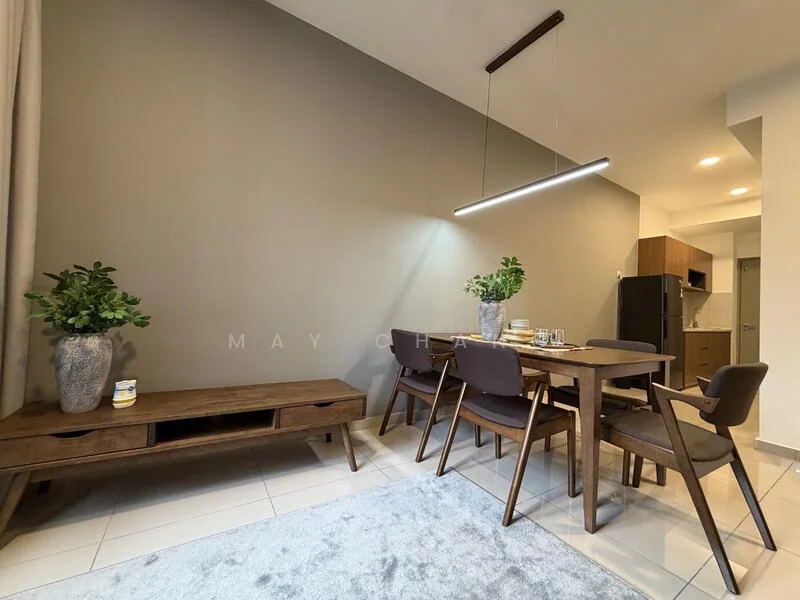Dining features: wooden dining table, 4 upholstered dining chairs, decorative vase with greenery, light grey area rug, wall-mounted light fixture, flat-panel kitchen cabinetry visible in background, black refrigerator visible in background, white tiled flooring, grey accent wall, open layout to kitchen; style: modern.