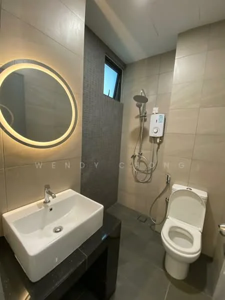 Bathroom features: wall-mounted shower with handheld attachment, round backlit mirror, white ceramic sink, chrome faucet, one-piece toilet, grey tiled walls, dark grey tiled flooring, shower wall with textured tiles, window for natural light; style: modern.
