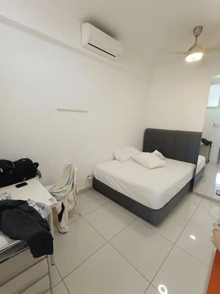 Bedroom features: queen-size bed with grey upholstered headboard, white bedding, white painted walls, glossy white tile flooring, 1 wall-mounted split AC, ceiling fan, study desk, metal storage cabinet, clothes on chair, natural light from doorway; style: modern.