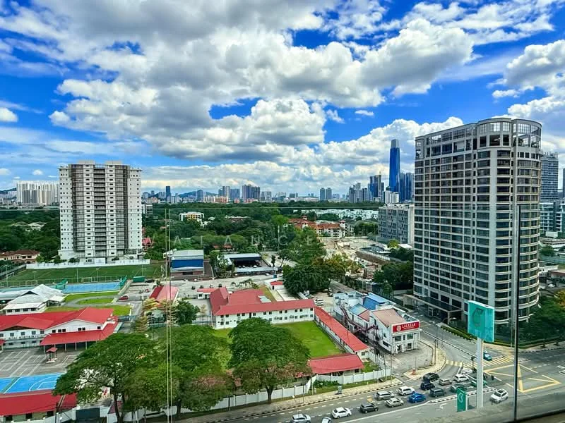 Exterior type: high-rise condominium; features: glass curtain wall, approximately 20-storey high-rise, surrounded by mature greenery, city skyline in background, manicured lawn, sports facilities visible, parking area, adjacent to highway; style: modern.
