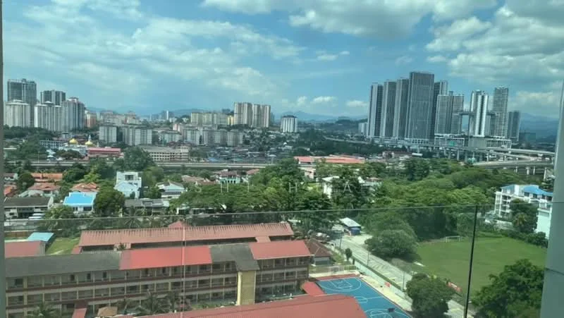 Exterior type: high-rise condominium; features: city skyline view, surrounded by greenery, basketball court visible, urban landscape, multiple high-rise buildings, low-rise residential buildings, clear blue sky, well-maintained grounds; style: modern.