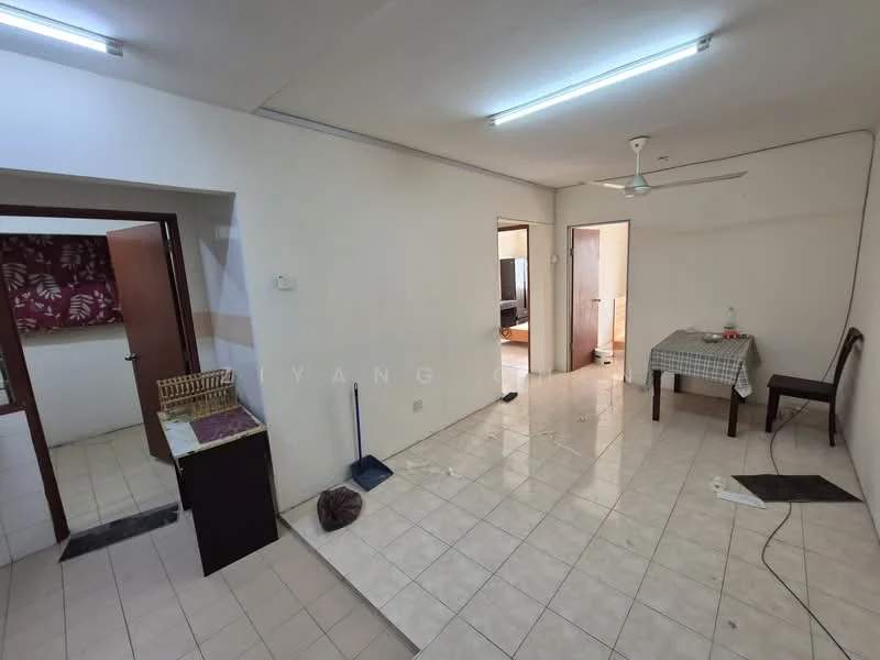 Room features: white painted walls, tile flooring, ceiling fan, fluorescent ceiling lights, dining table with checkered tablecloth, wooden chair, open layout, doorway leading to another room, kitchen area visible in background; style: minimalist.