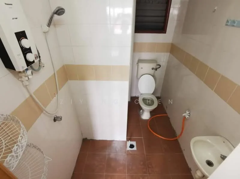 Bathroom features: white tiled walls, beige tiled accent strip, brown ceramic tile flooring, one-piece toilet, bidet, shower with wall-mounted water heater, shower head, window for natural light, drain on floor.