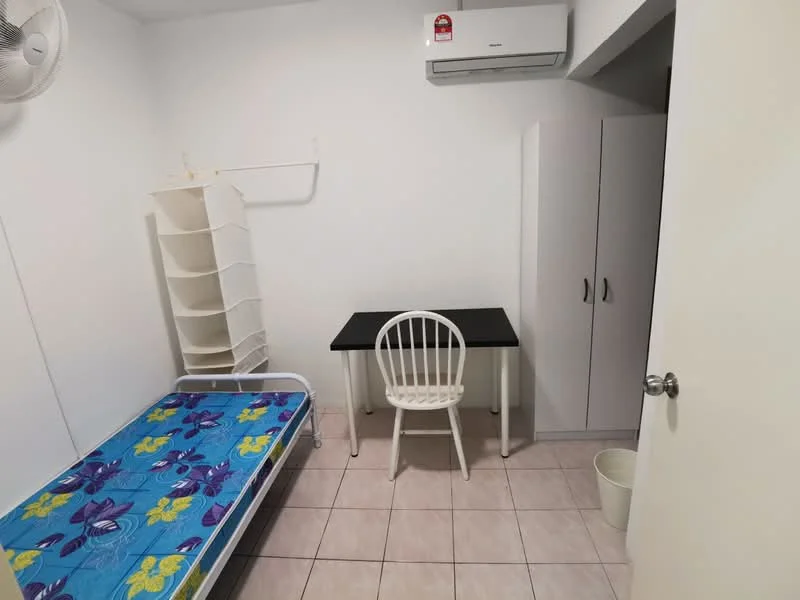 Bedroom features: single bed with blue floral bedding, white metal bed frame, white desk with black tabletop, white chair, built-in wardrobe, wall-mounted air conditioning unit, tile flooring, white painted walls, open shelving unit, waste bin; style: minimalist.