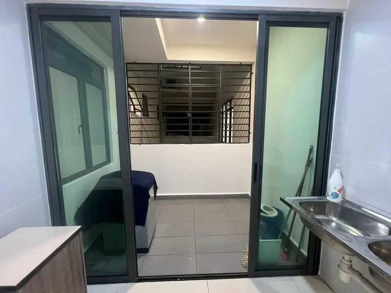 Room features: sliding glass door, grey tiled flooring, white walls, metal grille for security, sink with faucet, kitchen cabinetry, visible staircase in background, window with frame; style: modern.