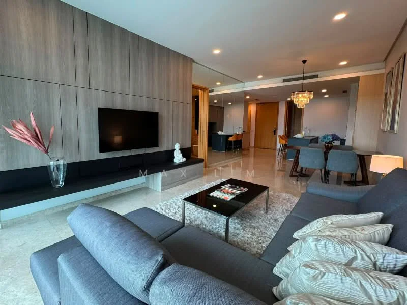 Living features: grey fabric sofa, coffee table, wall-mounted TV, feature wall with wooden paneling, marble flooring, area rug, chandelier, decorative vase, artwork on wall, dining area visible in background, recessed lighting; style: modern.