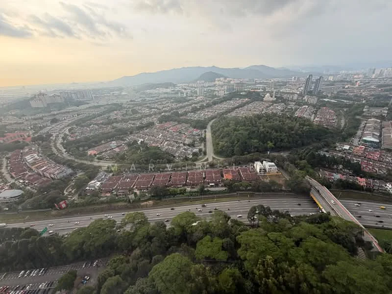 Exterior type: high-rise condominium; features: city skyline view, surrounded by greenery, highway visible, residential area below, mountain range in background, urban landscape, multiple buildings in view; style: modern.